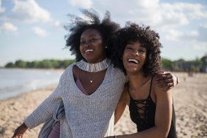 2 black women on afro hair at the beach